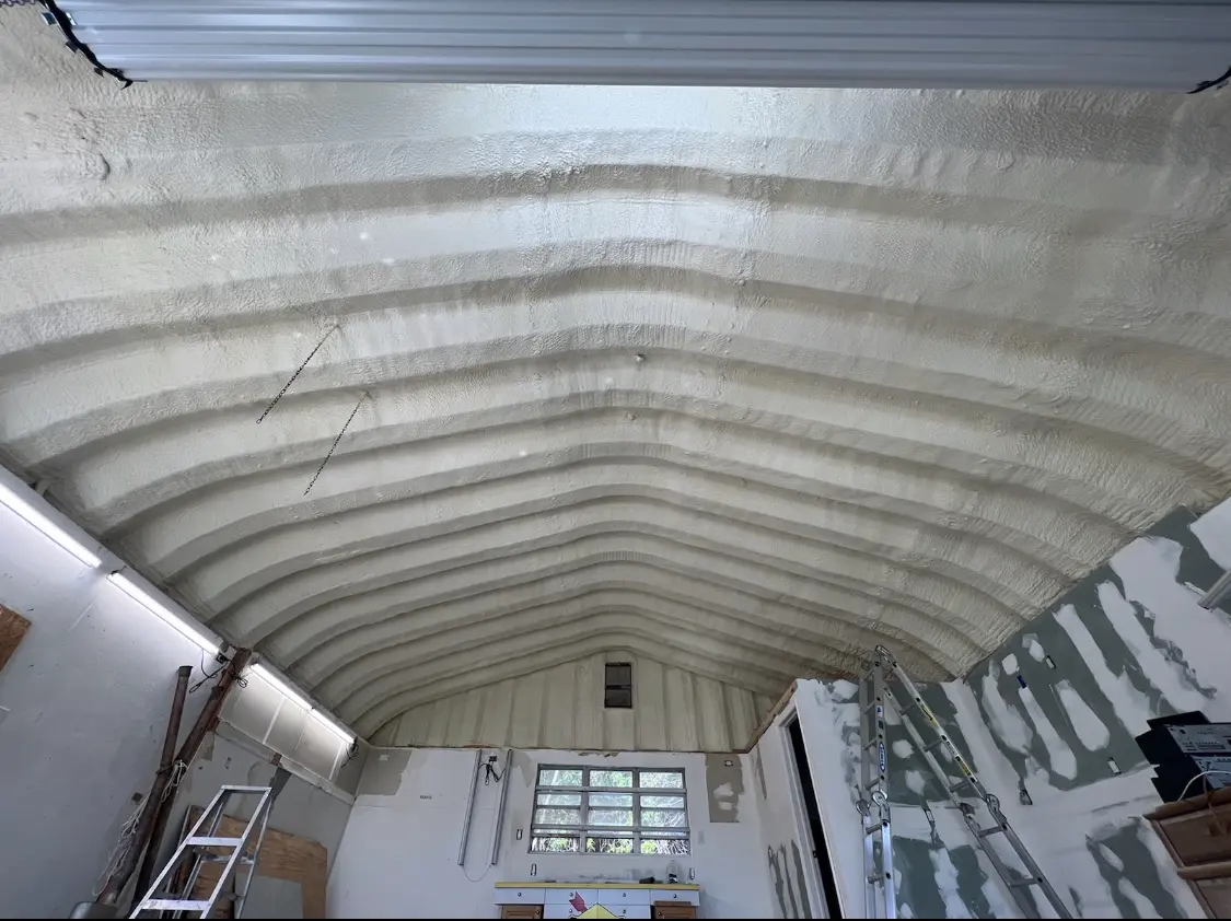Spray polyurethane foam applied to the underside of a metal roof deck in La Porte